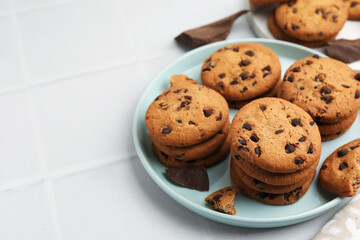 Delicious chocolate chip cookies on light table, closeup. Space for text