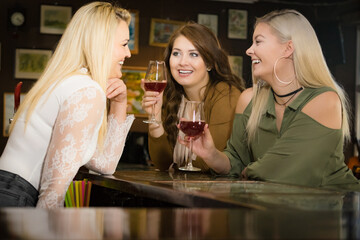 Girls with alcohol glasses in pub club