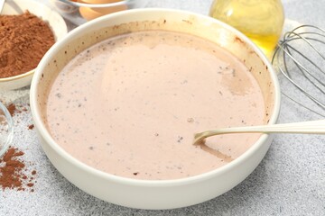 Chocolate dough and ingredients on grey textured table, closeup