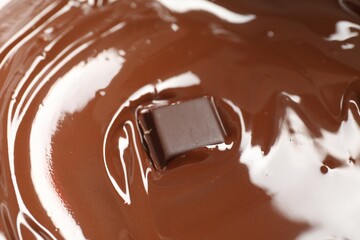 Tasty melted chocolate and piece as background, closeup