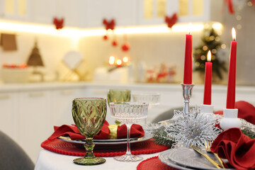 Festive table setting with Christmas decor in kitchen, closeup. Interior design