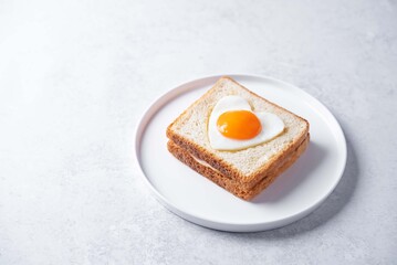 Heart shaped fried egg sandwich with ham and heart for Valentine's Day