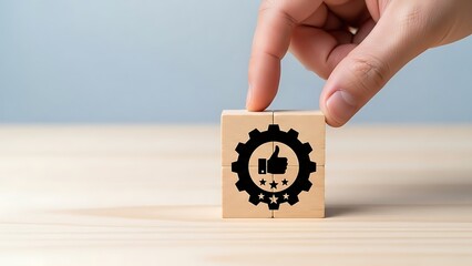 Hand placing wooden cube with customer satisfaction icon