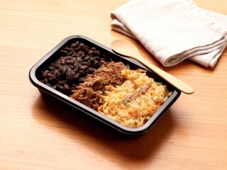 Black lunchbox with healthy fitness food.