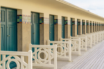 A row of famous blue-doored changing rooms on the coast of Deauville in Normandy, France