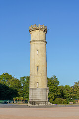 A round stone water tower in Honfleur in Normandy, France The sky is blue and clear in the evening