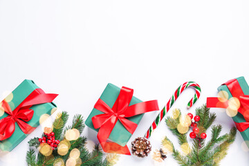 Wrapped Christmas gifts and decor on white background, flat lay. Space for text