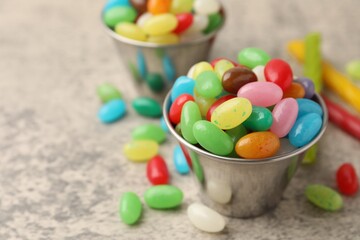 Delicious colorful candies on grey table, closeup. Space for text