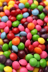 Many delicious colorful candies as background, closeup