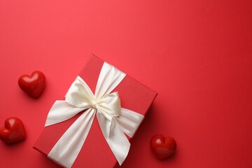 Beautiful gift and decorative hearts on red background, flat lay with space for text. Saint Valentine's day