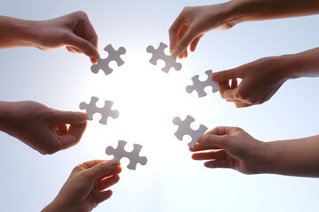 Hands Holding Puzzle Pieces - Teamwork and Strategy Concept