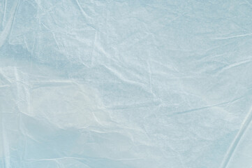 Light shines through crumpled plastic wrap on a table