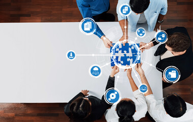 A diverse team collaborates around a puzzle globe, symbolizing innovative management strategies and teamwork in a modern business environment. Amity