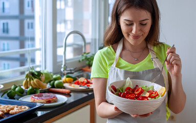 young woman eating salad