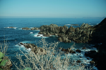 Rocky cliffs descending into the sea. Scenic ocean view