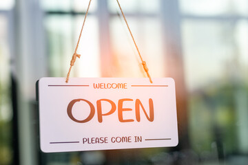 Welcome. Open sign board, waitress woman turning open sign board on glass door in modern cafe coffee shop ready to service, cafe restaurant, retail store, small business owner, food and drink concept