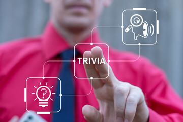 Business person using virtual touch screen presses the word TRIVIA. Trivia Business Competition Cognition concept. Trivia time.