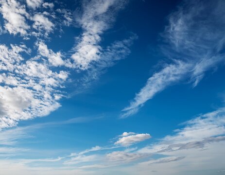 expansive blue sky filled with wispy white clouds natural background - Powered by Adobe