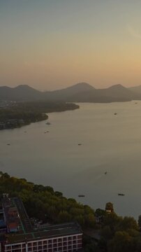 sunny sunset hangzhou city famous lakeside bay tourist ferry traffic aerial vertical timelapse panorama 4k china