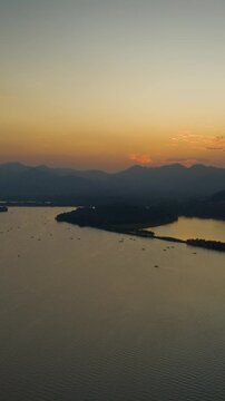 sunset hangzhou city famous lake boat ferry traffic aerial vertical timelapse panorama 4k china