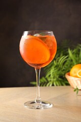 Refreshing spritzer cocktail with mint on wooden table