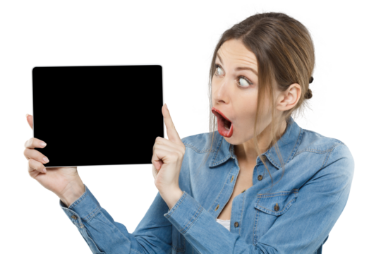 Surprised young woman in denim pointing at a blank black tablet screen, showing copy space - Powered by Adobe