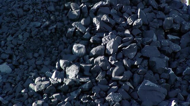 Iron Ore Chunks Falling From Conveyor, Mining Stockpile Close Up, Argentina - 4K