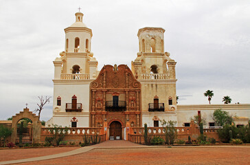 San Xavier Del Bac Mission on the Tohono Oodham reservation in the village of Wark, near Tucson, Arizona, USA with light colored sky copy space, is an example of Spanish Colonial Architecture.