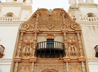 Close-up of ornate balcony and entrance to San Xavier Del Bac Mission on the Tohono Oodham reservation in the village of Wark, near Tucson, Arizona, USA.