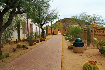 Garden and sidewalk outside San Xavier Del Bac Mission on the Tohono Oodham reservation in the village of Wark, near Tucson, Arizona, USA.
