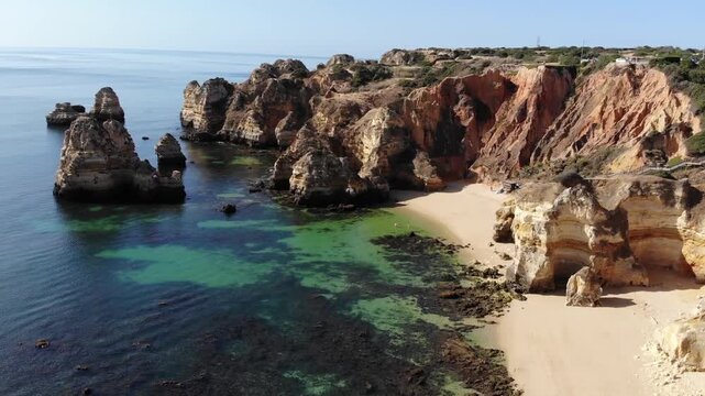 Lagos camilo beach Sunny View of Lagos Cliffs and Small Beach Cove with Clear Turquoise Water, Travel and Vacation Destination in the Algarve, Portugal, Shoreline View