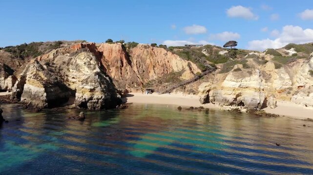 Camilo beach in Lagos Wide Angle View of Coastal Cliffs and Rocky Beach Cove with Clear, Vibrant Blue Ocean Water, High Dynamic Range, Sunny Summer Travel Destination
