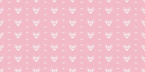 Delicate seamless pattern of white ornate hearts with lace-like details and small dots on a light pink background