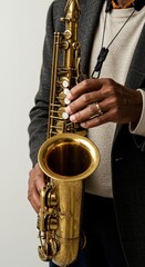 Obraz premium Saxophone held by musician in studio portrait