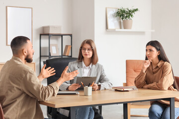 Female family mediator working with couple in office