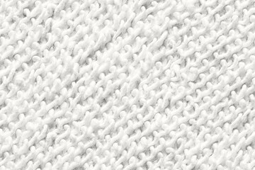 Close-up of soft white knitted wool texture for winter clothing and cozy home decor designs. © elenavolf