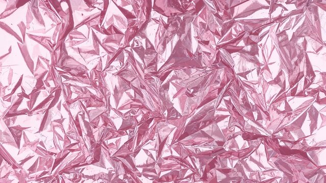Crumpled pink foil with a shiny, textured appearance.