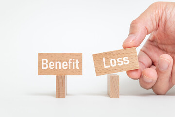 There is wood block with the word Benefit or Loss. It is as an eye-catching image.