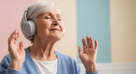 Naklejka premium Elderly woman with gray hair wearing headphones and smiling. Using music for therapy, relaxation, and mental health in old age.