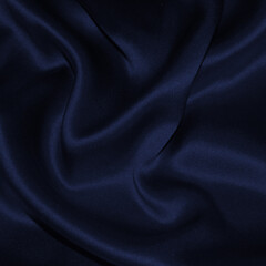 Dark navy blue satin fabric texture, elegant silky folds, luxury drapery background, smooth textile, night blue cloth for fashion, branding, posters.