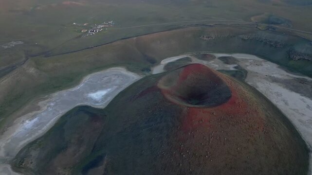 Meke volcano crater lake drone aerial view featuring striking red colors and a desolate landscape in Turkey
