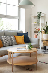 Interior of stylish living room with sofa, table and plants