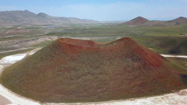 Drone aerial view of Lake Meke drying volcanic crater lake with red landscape in Turkey