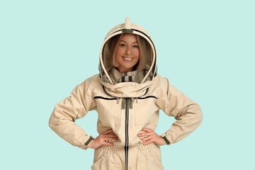 Fototapeta premium Female beekeeper on blue background