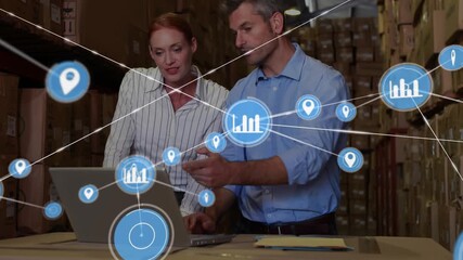 Woman leaning, man typing at laptop in warehouse, data nodes growing over screen, checking stock - Powered by Adobe