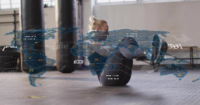 Woman in gym initiating torso twisting in med ball V-sit, building core while HUD map overlaying