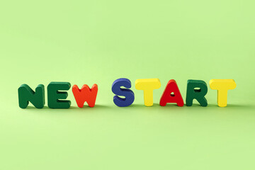 Text NEW START on green background