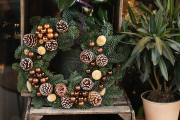 Christmas wreath with branches cones and golden balls