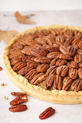 Tasty pecan pie on light background
