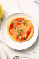 Plate with tasty mini pizza on white background